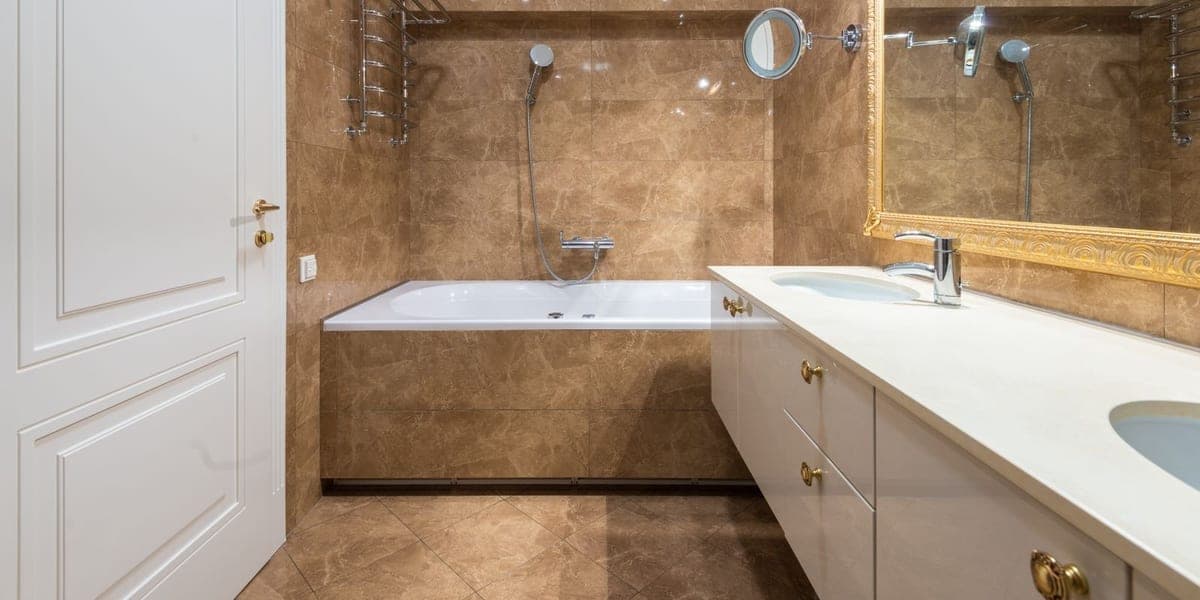 A bathroom with a large wall mirror and a smaller round adjustable mirror